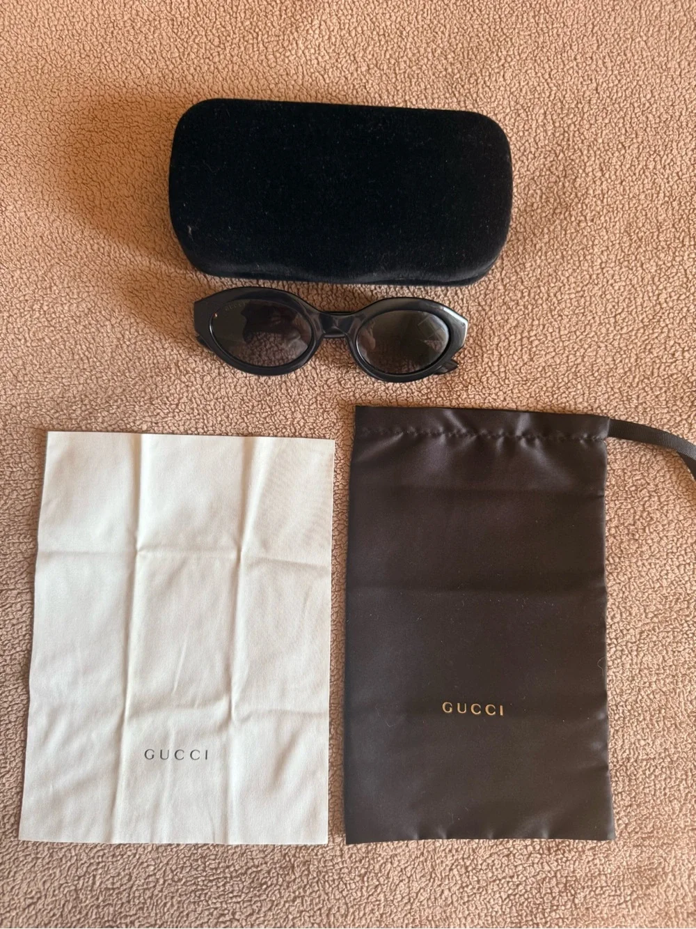 Gucci Black Oval Sunglasses with Gold Logo Accent
